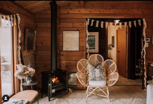 Electric fireplace made to look like a traditional wood burning fireplace, in a rustic log cabin
