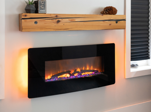 Wall mount Dimplex electric fireplace with rough cut mantle and mini speaker in a condo.