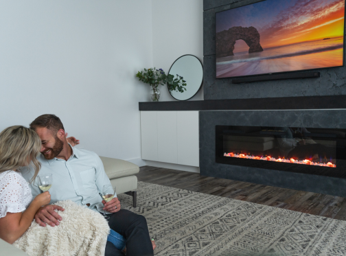 couple sitting in front of a Sierra fireplace