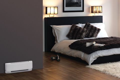 Bedroom with baseboard heater at the bottom of a wall