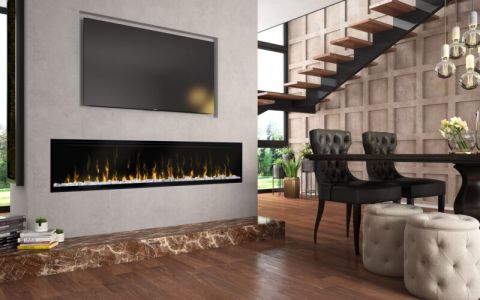 Dining room with room divider wall with linear electric fireplace and TV above.