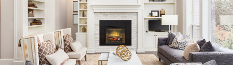Dimplex Revillusion Built-In Firebox set into a white mantle at the center of a large family room. 